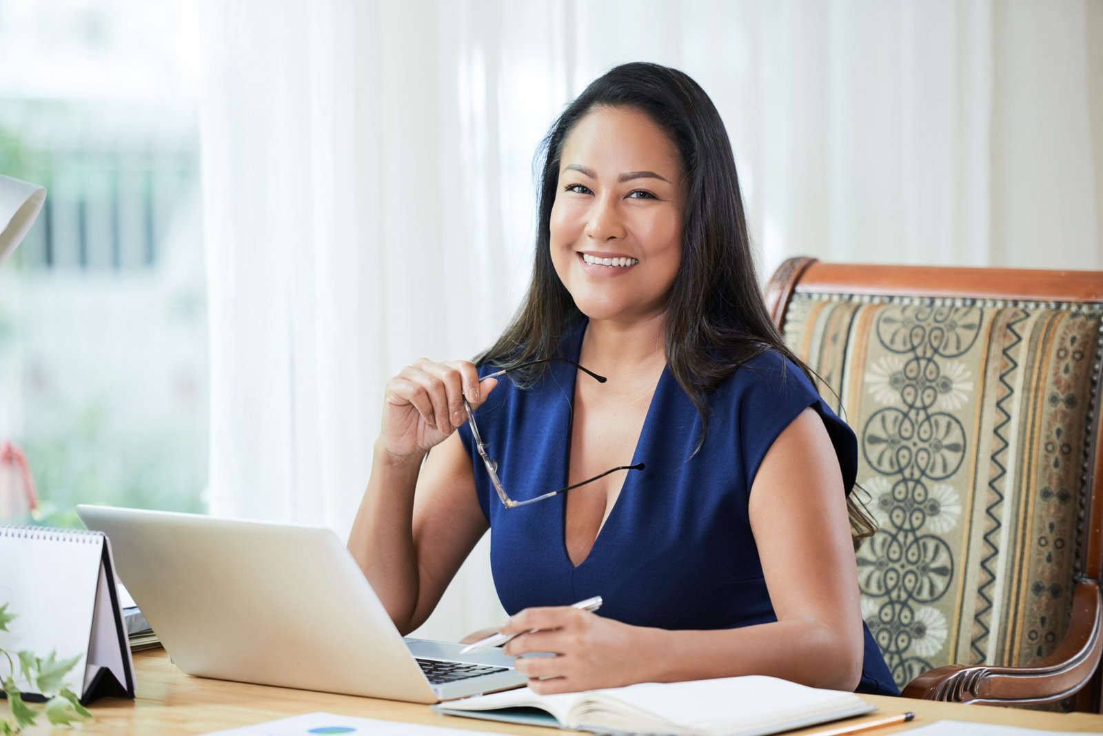 adult-smiling-businesswoman-at-working-desk-2023-11-27-04-56-23-utc-min